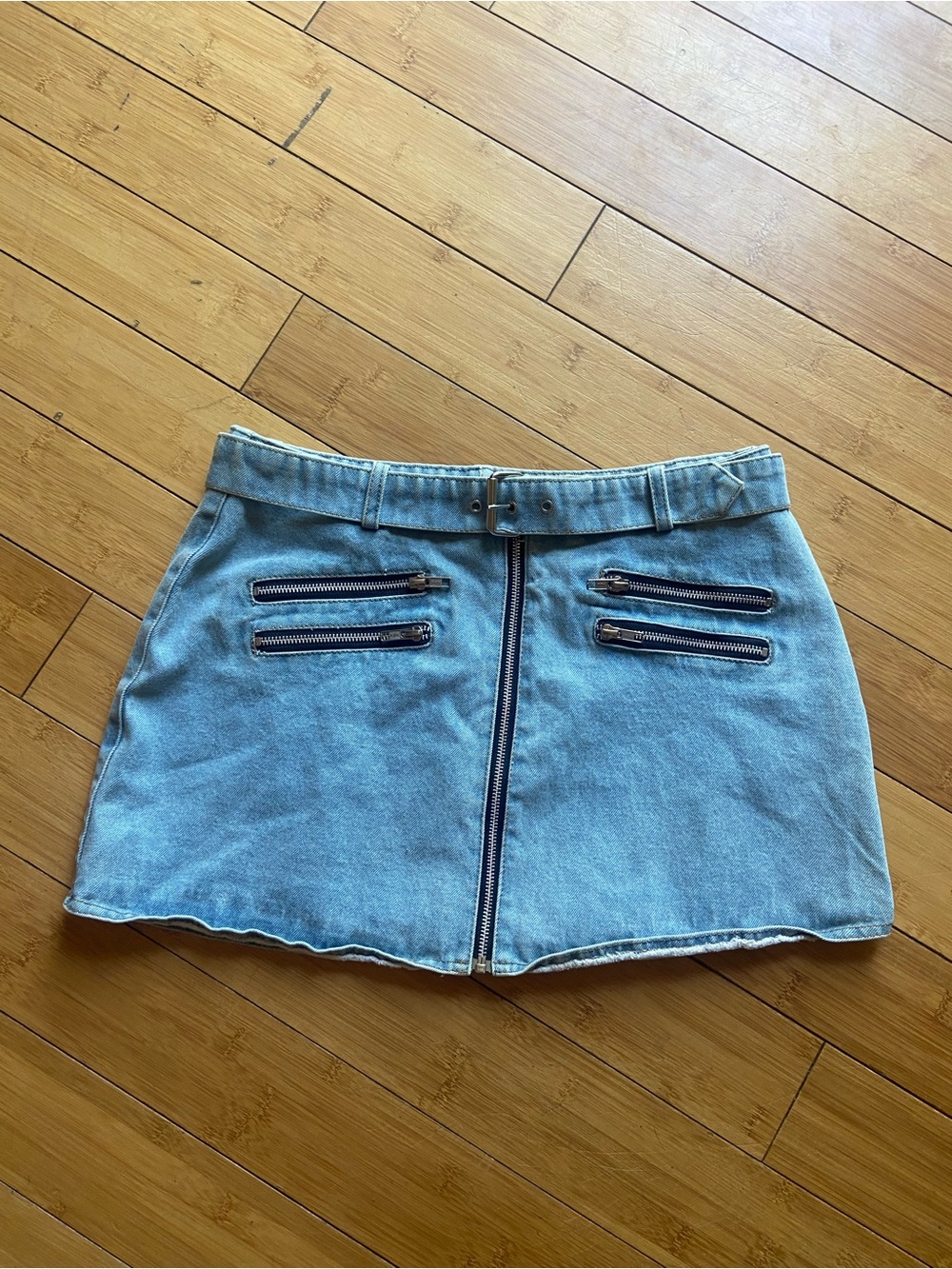 Light Blue Denim Mini Skirt with Front Zip and Decorative Pockets